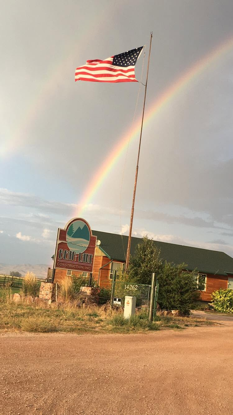 Bear Lake Construction Inc. sign with American flag and rainbow